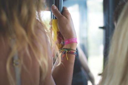 Primary school students wearing colourful safety and educational wristbands