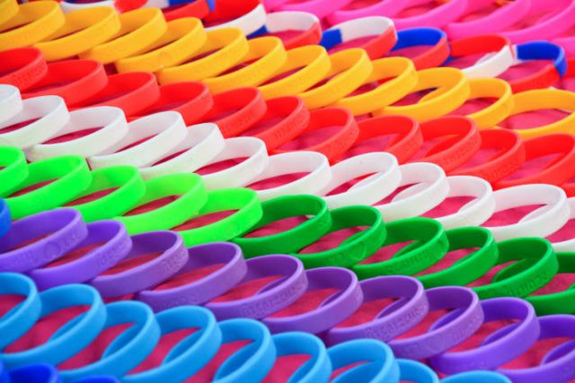 Rainbow pattern silicone wristbands showing variety of handband uses