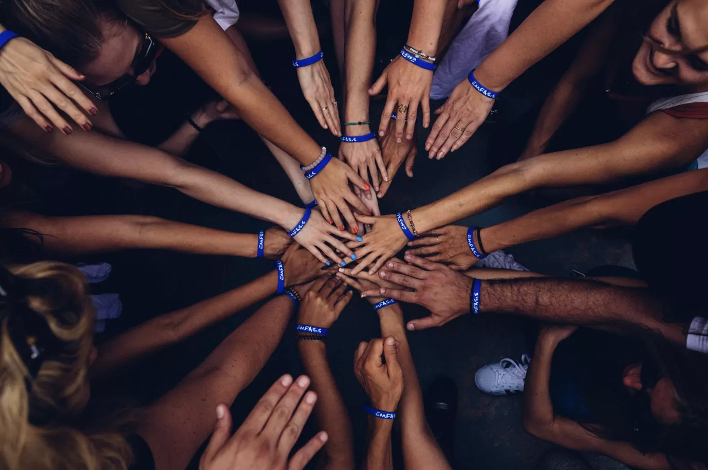 Charity supporters wearing awareness wristbands at a fundraising event