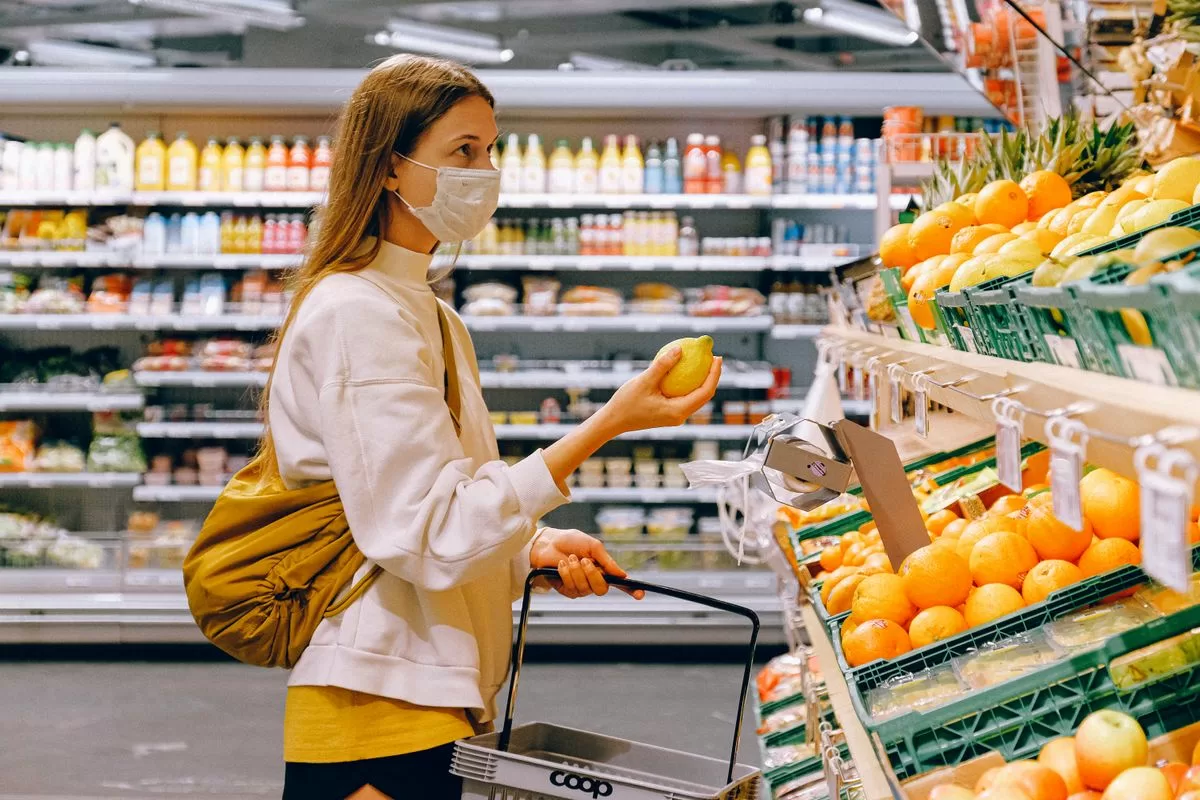 Adult shopper reading food allergen labels in Australian supermarket