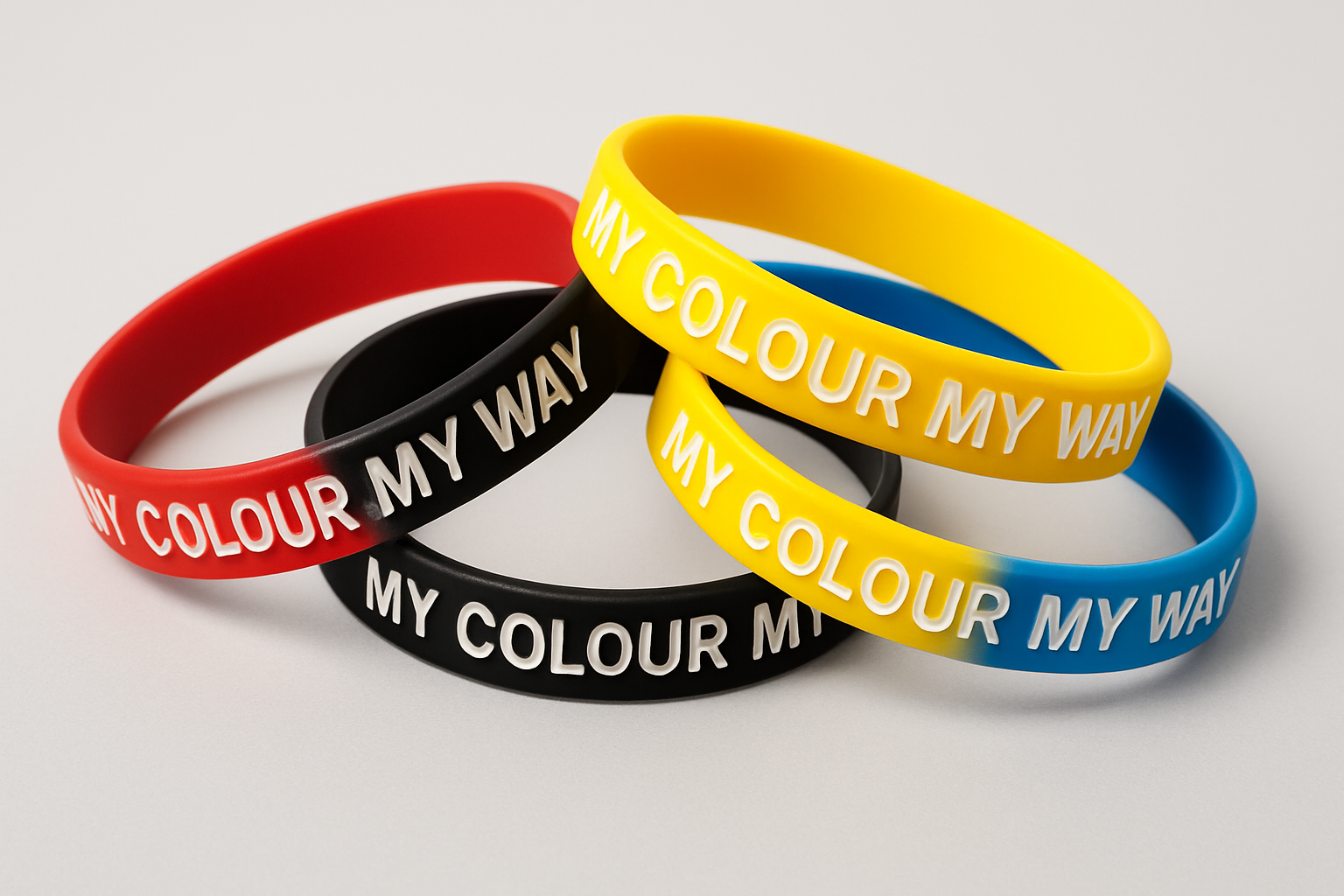 Four colourful custom silk screen printed silicone wristbands with My Colour My Way text