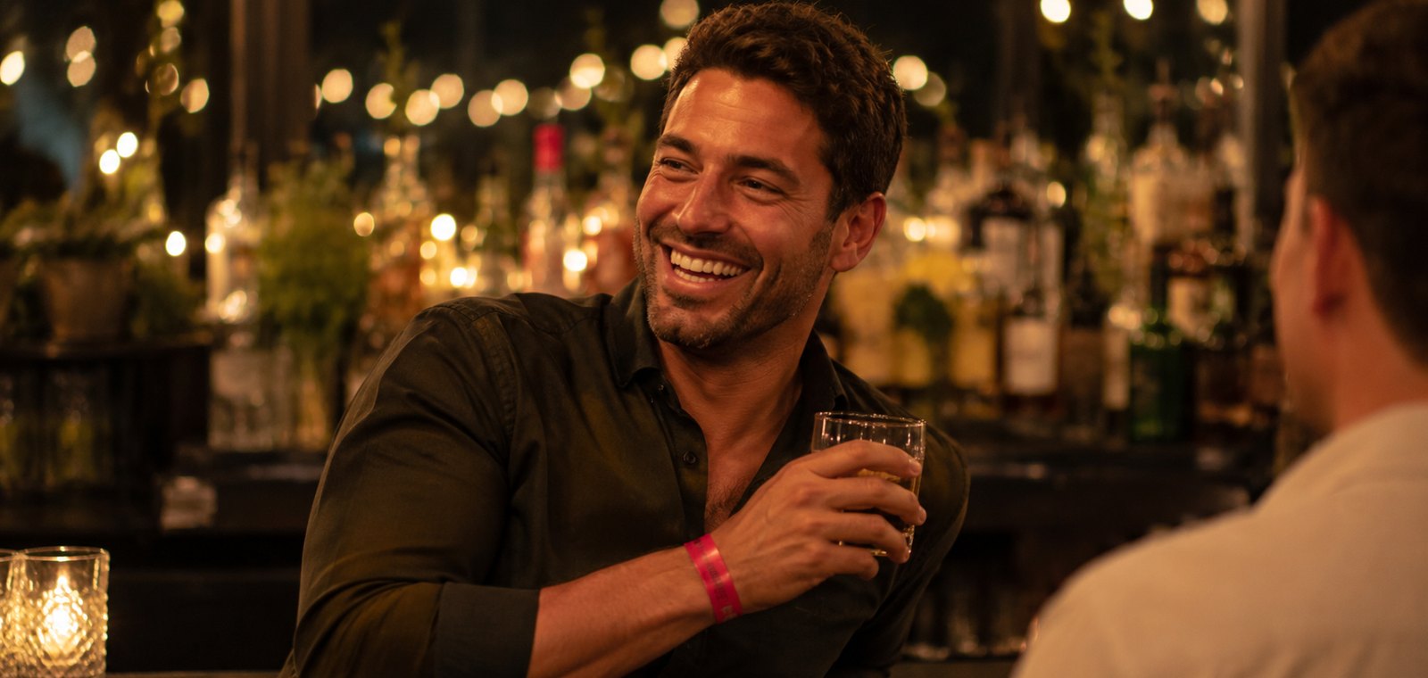 Work Christmas party guest wearing a custom drink-tier event wristband at the bar