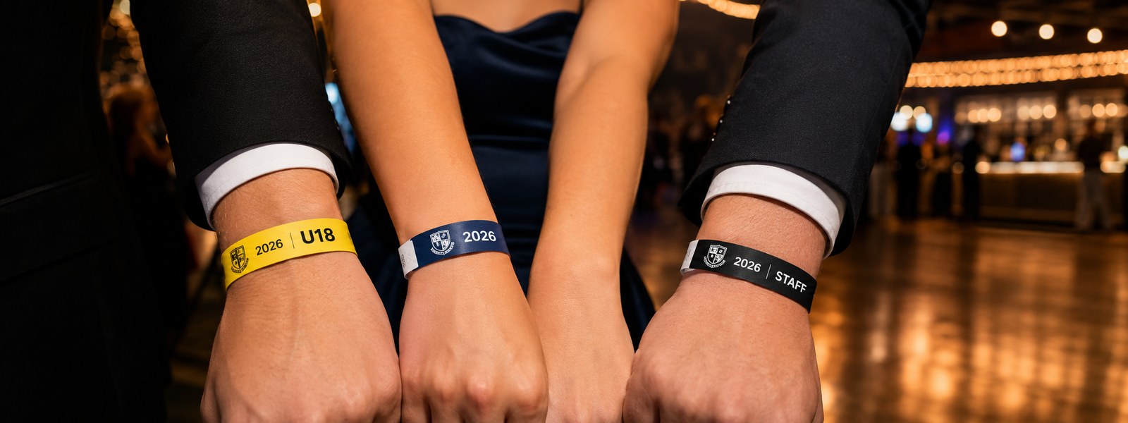 Year 12 students wearing school formal wristbands at the venue entry