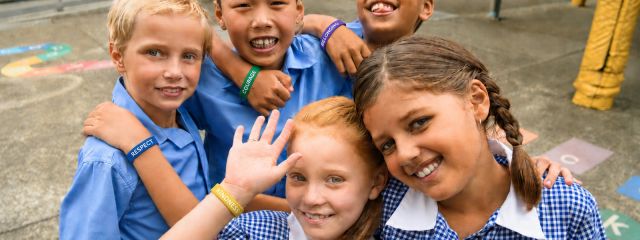 School students wearing message wristbands for an anti-bullying campaign