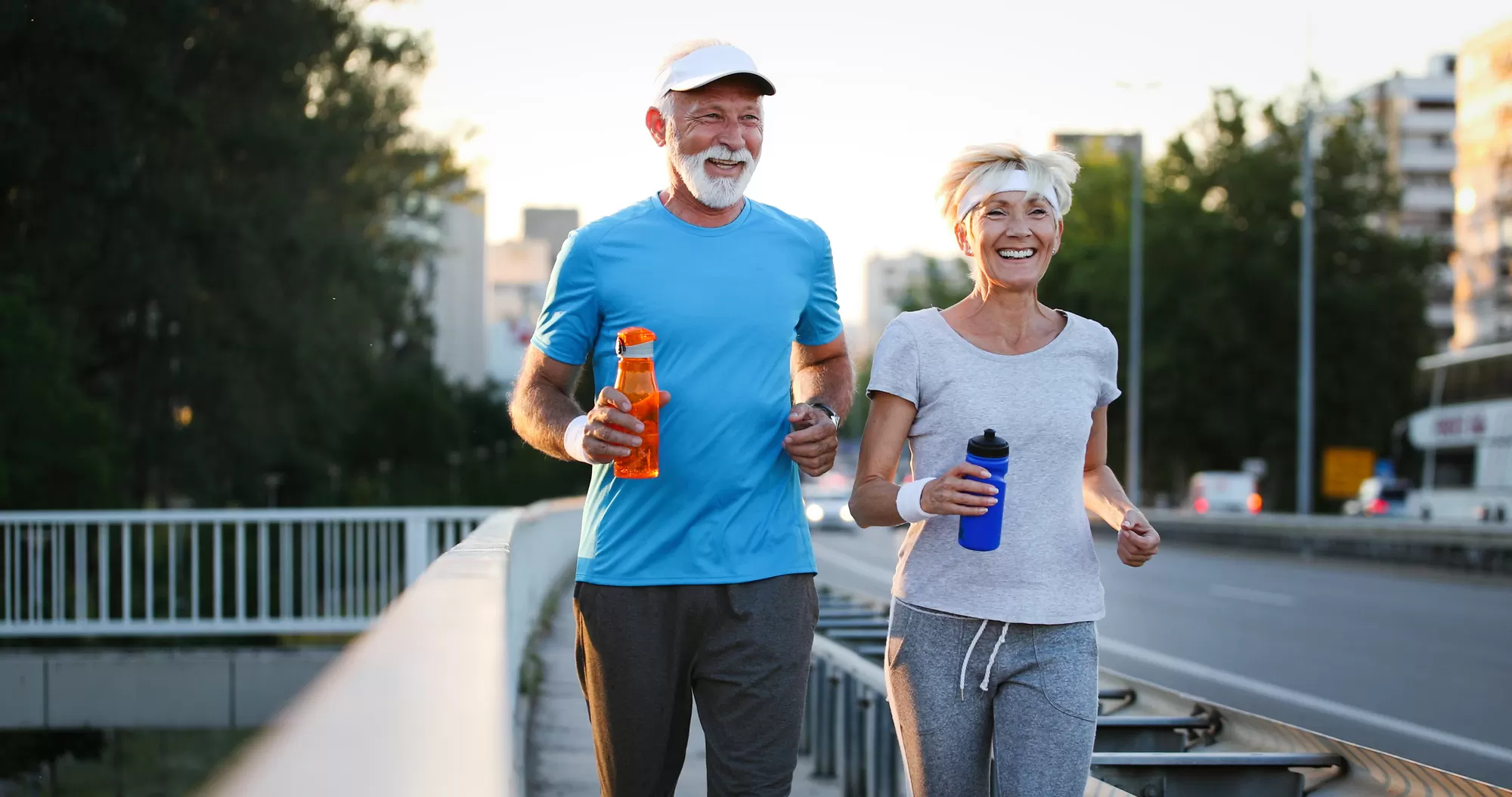 Happy mature couple exercising — perseverance and visible cues for daily habits