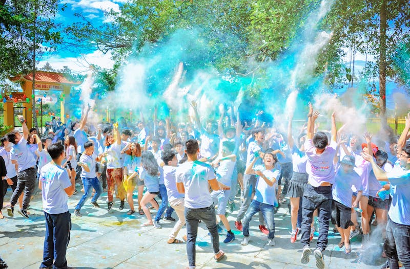 Teacher checking students wearing colourful identification wristbands on a school excursion