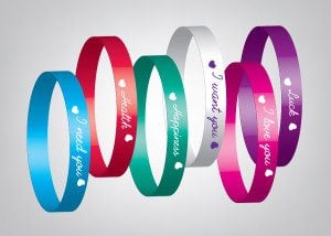 Silicone wristbands and plastic bracelets lined up